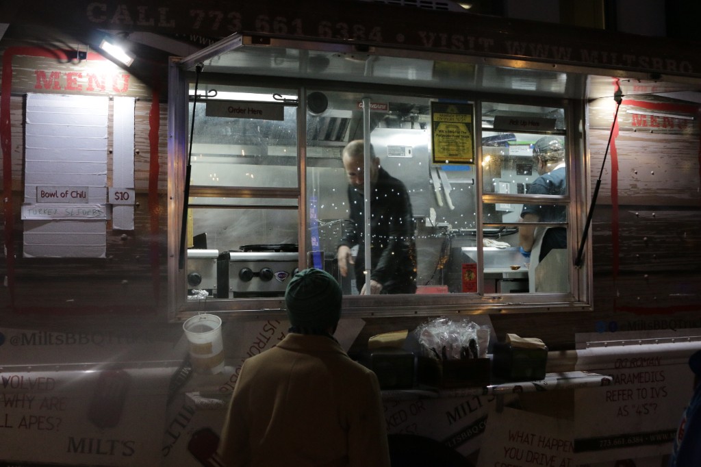 Concert view from the crowd toward the stage with crisscrossing string lights in the sky