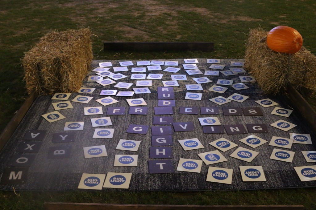 Musicians and drum kit glowing under intense pink stage wash at Gallagher Way