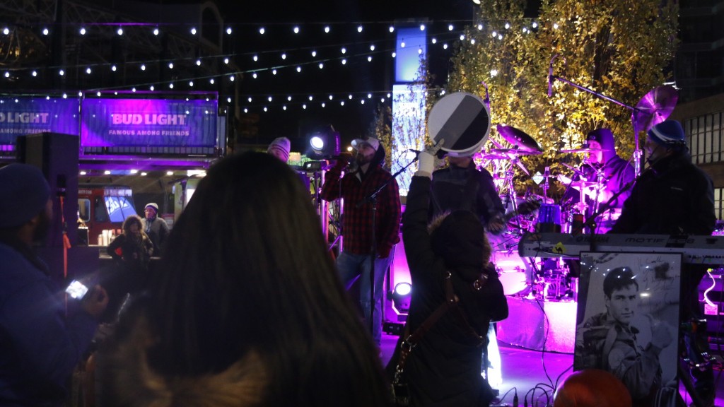 Closing wide shot of the plaza, lights, and Wrigley Field exterior at night