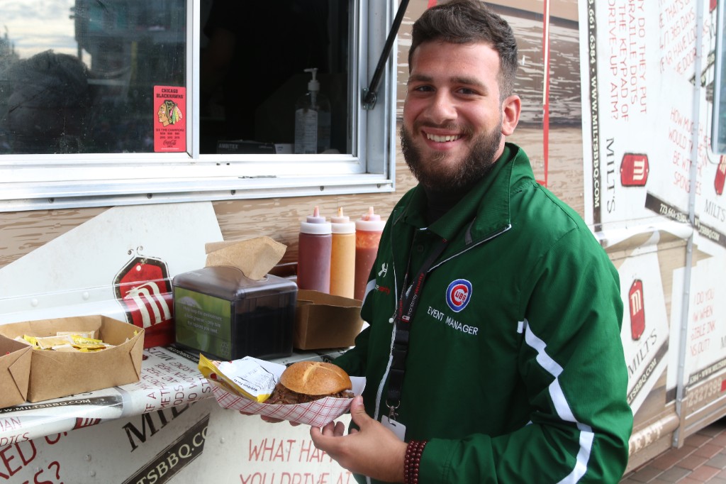 Cubs event staff with food from the Milt&rsquo;s BBQ truck at Wrigley Field