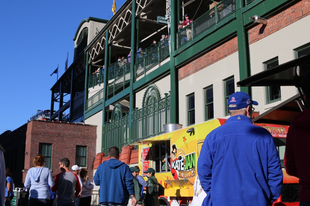 Food trucks and picnic tables with crowds on Gallagher Way