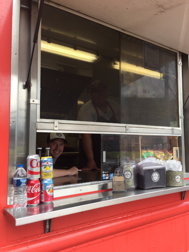The Fat Shallot food truck service window with staff and drinks at Wrigley Field